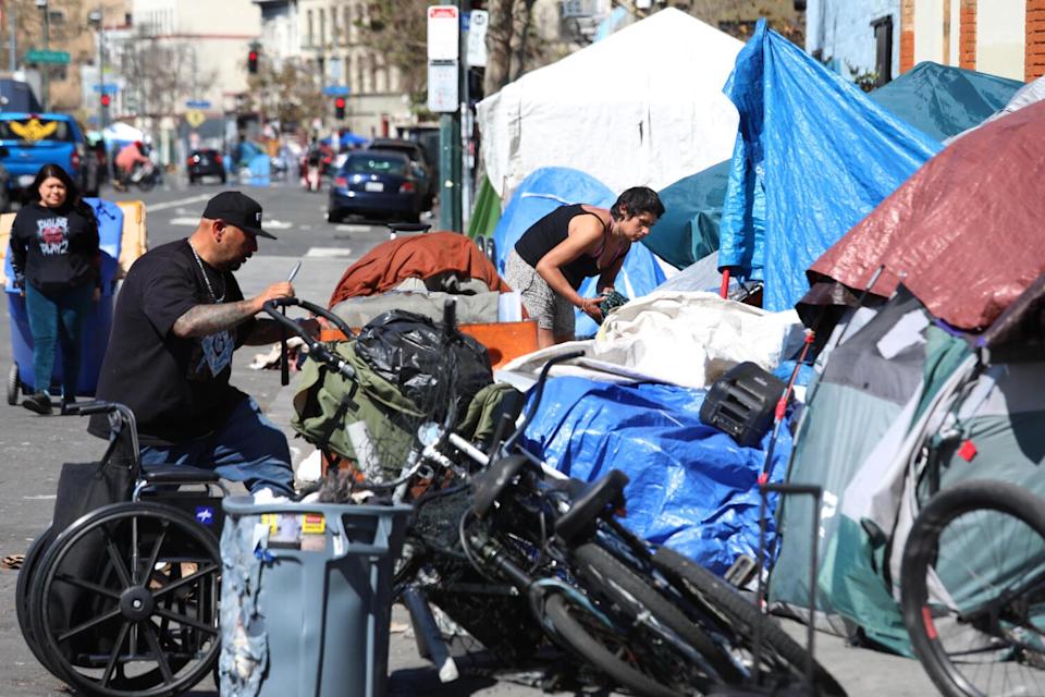 People outside tents on Skid Row.