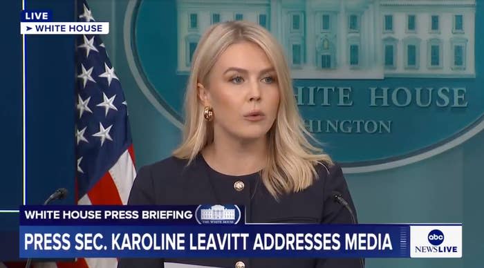 Person speaks at White House press briefing podium, addressing media