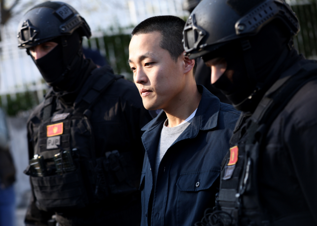 Police officers escort Do Kwon after he served sentence in prison for document forgery on March 23, 2024 in Podgorica, Montenegro. 
