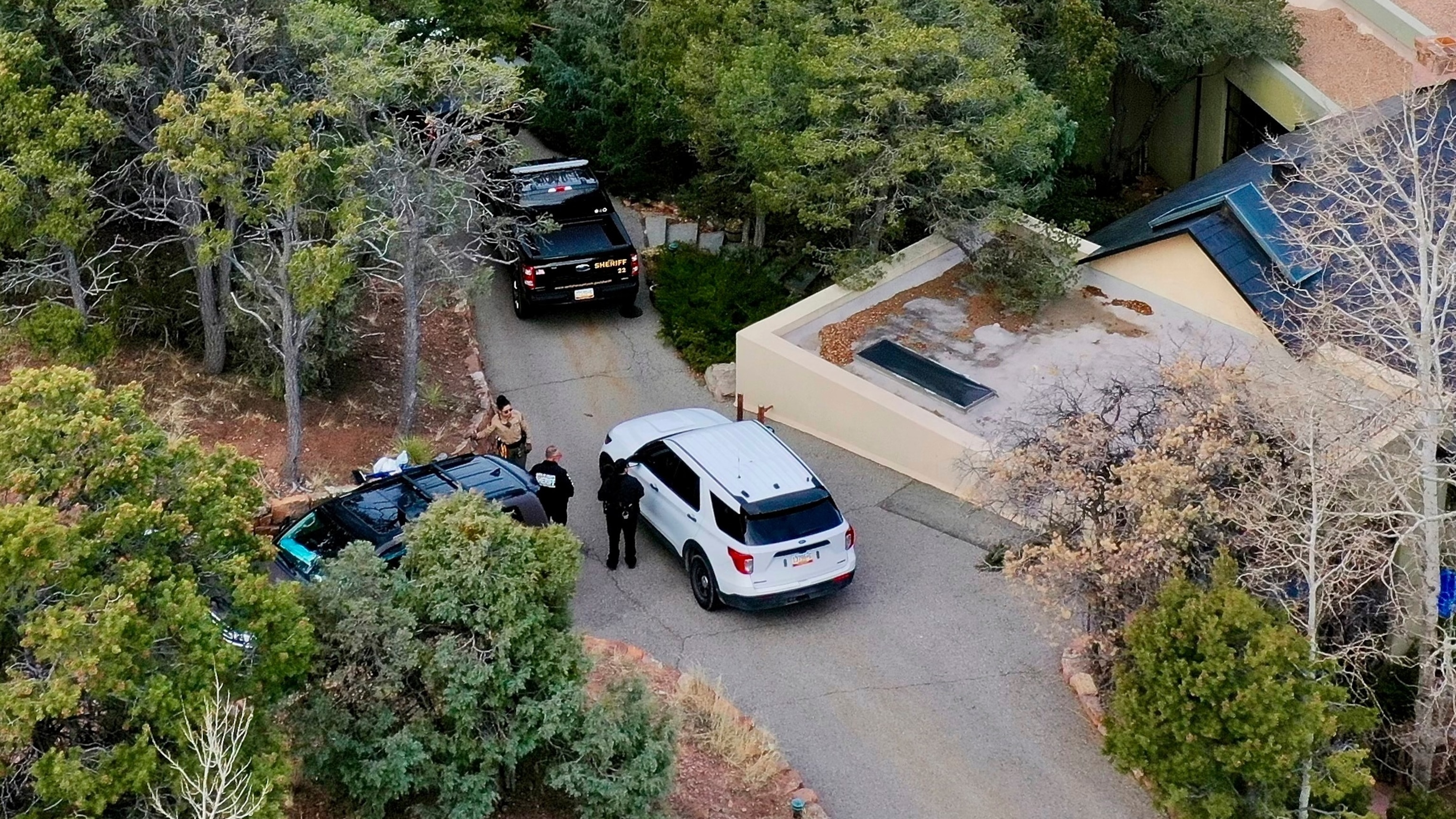 PHOTO: Law enforcement officials talk outside the home of actor Gene Hackman on Feb. 27, 2025 in Santa Fe, N.M.