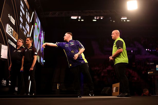 LIVERPOOL, ENGLAND - APRIL 24:  Michael van Gerwen and Luke Littler during their match at M&S Bank Arena on April 24, 2025 in Liverpool, England. (Photo by Carl Recine/Getty Images)