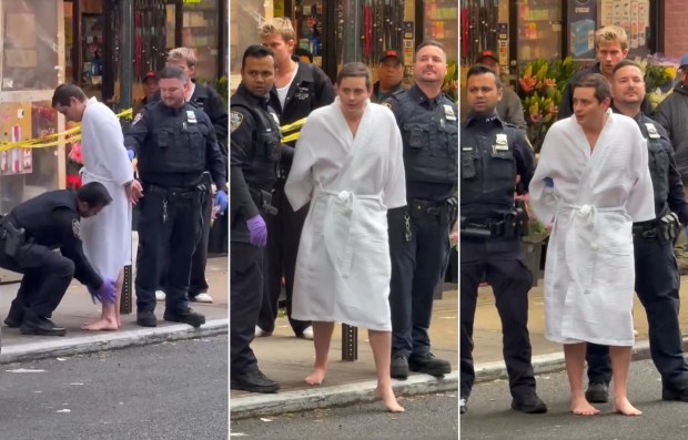 NYPD police officers remove John Woeltz, 37 from a home on Prince St. near Mulberry St. in Manhattan on Friday, May 23, 2025, after a man claimed he was held against his will at the location. (Obtained by New York Daily News)