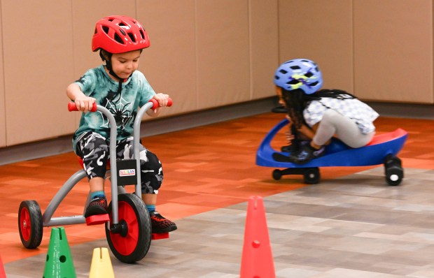 Jeremiah Rivera and Aliah Bautista Carrasco ride around the room...