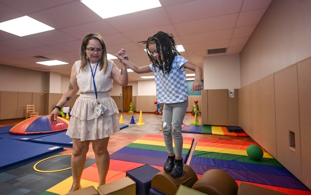 Teacher Enid Marrero interacts with Aliah Bautista Carrasco during gym...