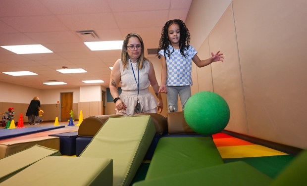 Teacher Enid Marrero interacts with Aliah Bautista Carrasco during gym...