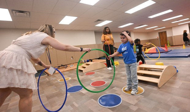 Teacher Enid Marrero interacts with her students during gym class...