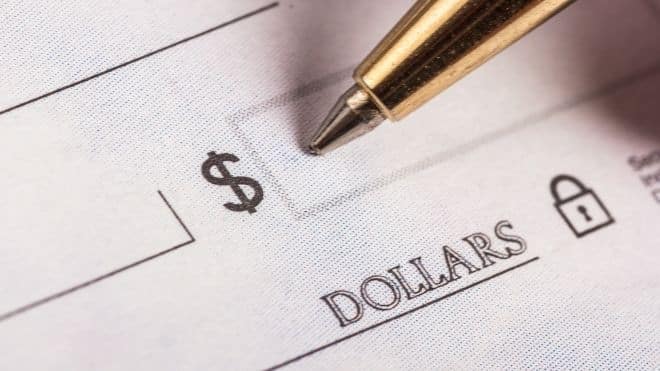 Banking showing a person writing a check.
