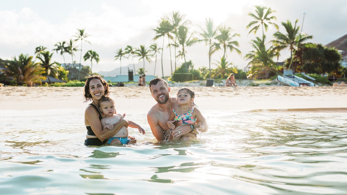 Family enjoying the ocean water while on vacation