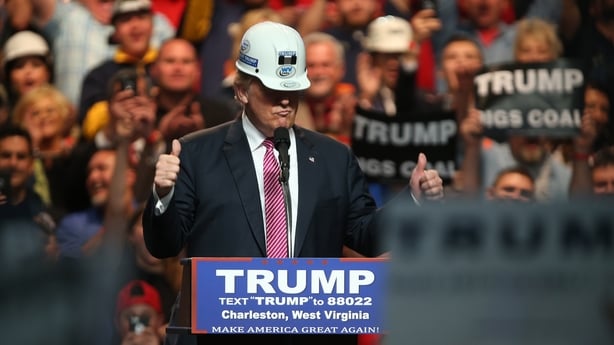 CHARLESTON, WV - MAY 05: United States Republican Presidential candidate Donald Trump models a hard hat in support of the miners during his rally at the Charleston Civic Center on May 5, 2016 in Charleston, West Virginia. Trump became the Republican presumptive nominee following his landslide win in