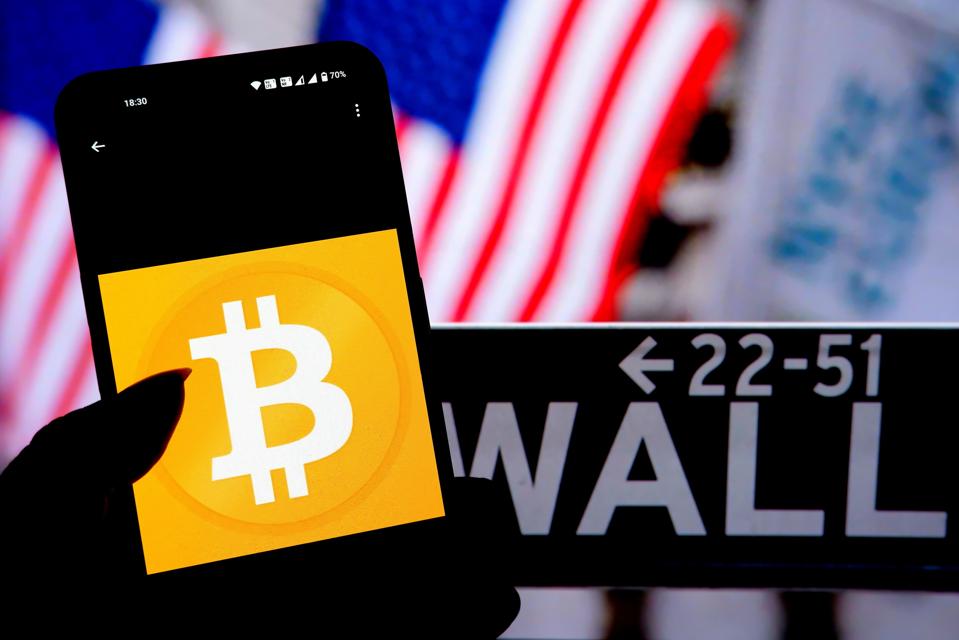 In this photo illustration, a Bitcoin Logo seen displayed on...