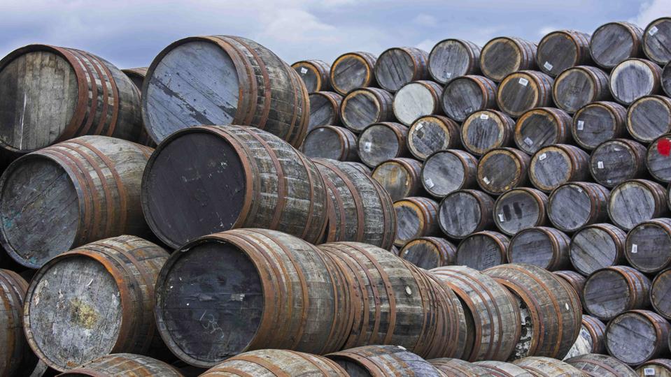 Huge stacks of discarded whisky barrels at Speyside Cooperage.