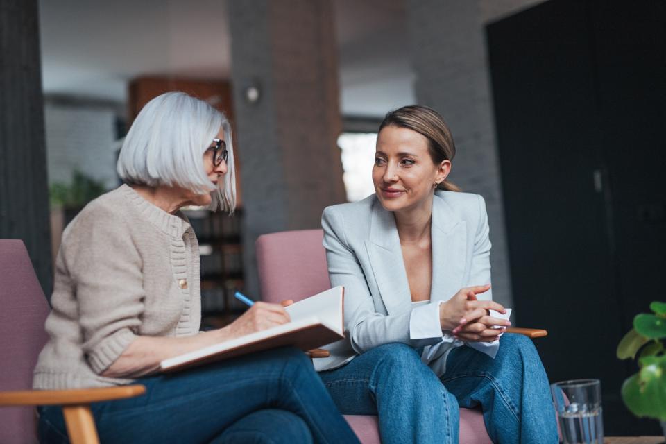 Workplace mental health coaching for female manager. Mental health coach helping to navigate stress, anxiety and manage work life balance for female worker.