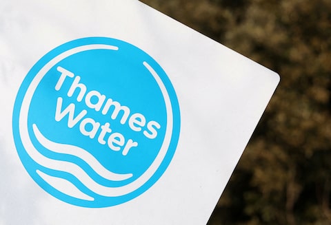 A Thames Water logo is seen on a sign in London