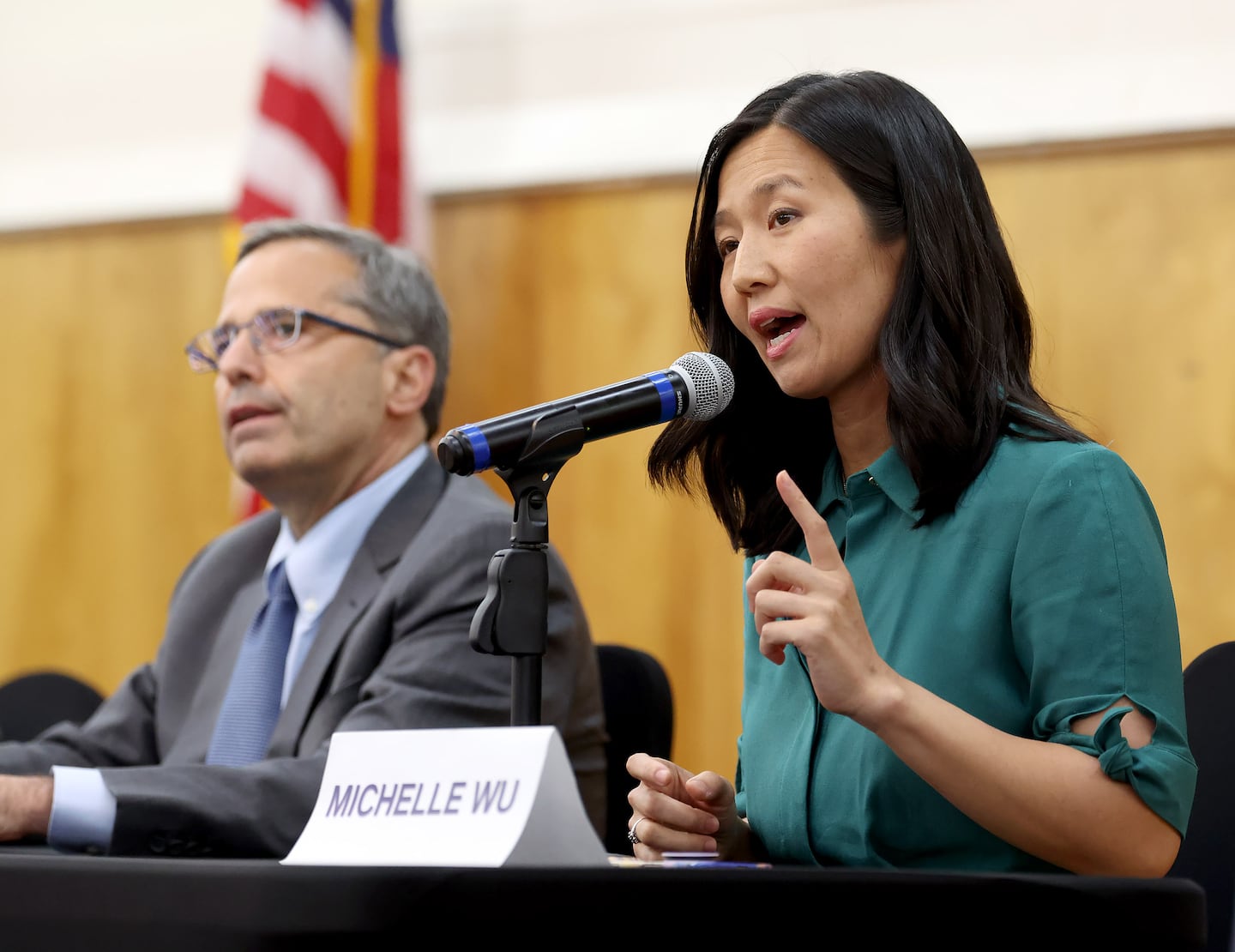Boston mayoral candidate Josh Kraft, listens as Boston Mayor Michelle Wu speaks during a mayoral forum at the William E. Reed auditorium.
