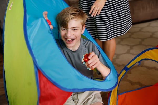 Stetson Ely, 12, plays at his home in Canton on Friday, May 30, 2025. At 17-months-old, Stetson was diagnosed with Angelman syndrome, a rare neurogenetic disorder. (Natrice Miller/ AJC)