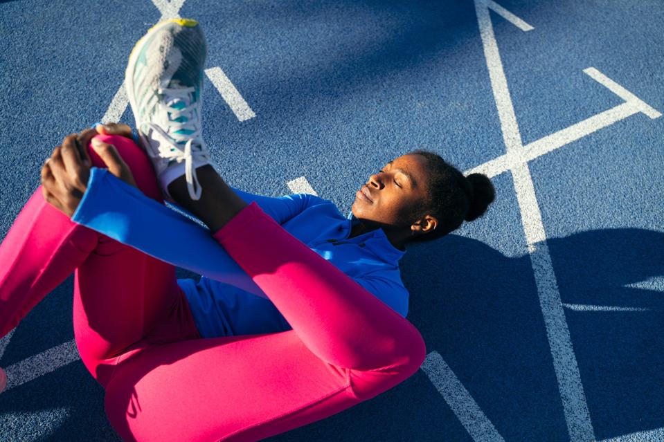 Young black woman stretching.
