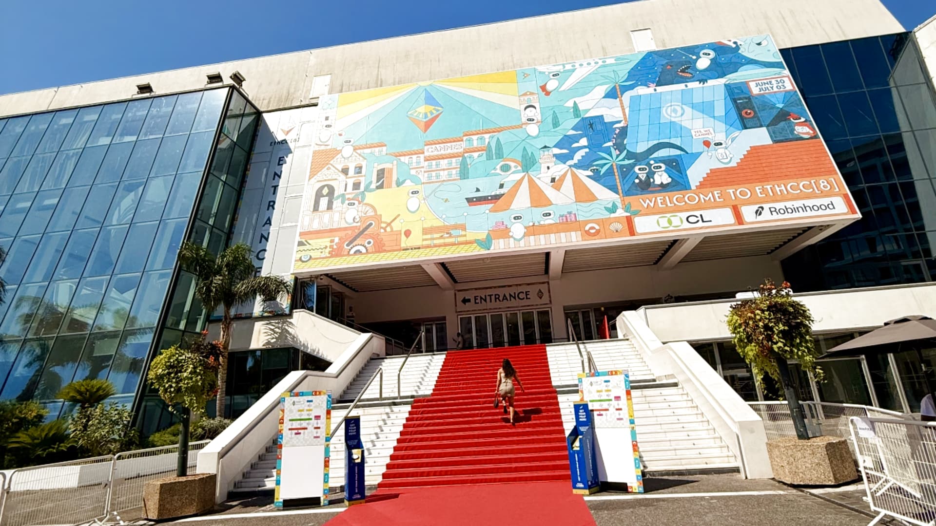 Crypto founders and developers climb the iconic red-carpeted steps of the Palais des Festivals — a familiar backdrop for the Cannes Film Festival, now repurposed for Ethereum’s flagship European event.
