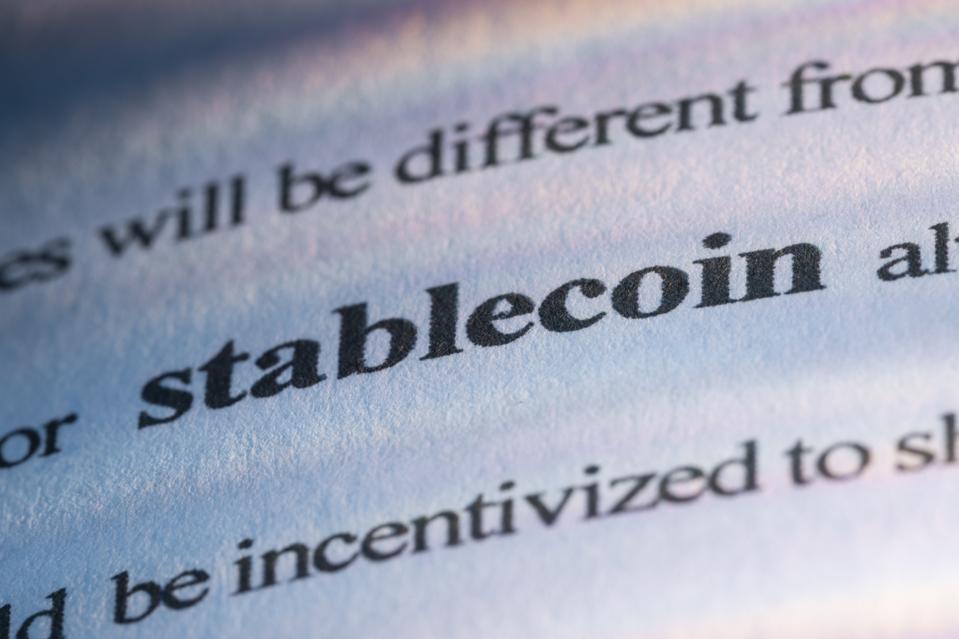The word "stablecoin" on a printed page for the topic of how do stablecoins work