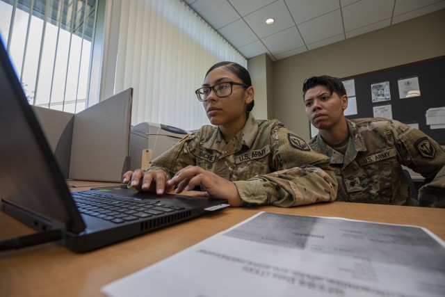SPC Savanna Sanchez, left, and SPC Joyce Marrero, both from New Jersey's 350th Finance Detachment, go over contracting information during Exercise Diamond Saber, the Army's largest finance exercise, basing operations out of the National...