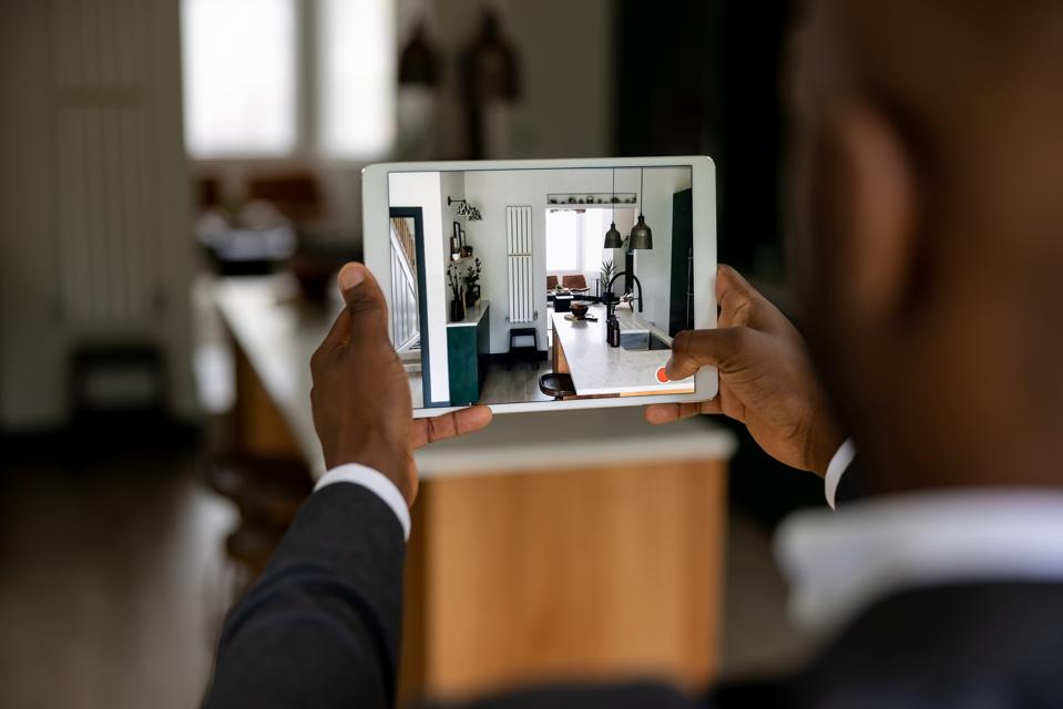 Real estate agent making a virtual tour of a house using a tablet