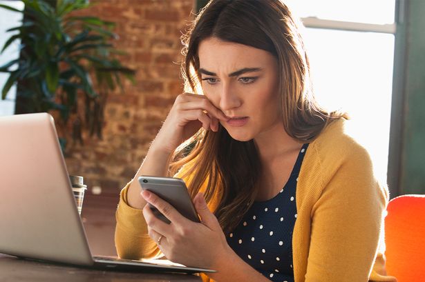 A woman checks her phone