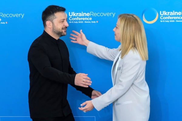 Ukrainian President Volodymyr Zelenskyy is welcomed by Italian Prime Minister Giorgia Meloni during the Ukraine Recovery Conference at La Nuvola convention center in Rome, Thursday, July 10, 2025. (Mauro Scrobogna/LaPresse via AP)