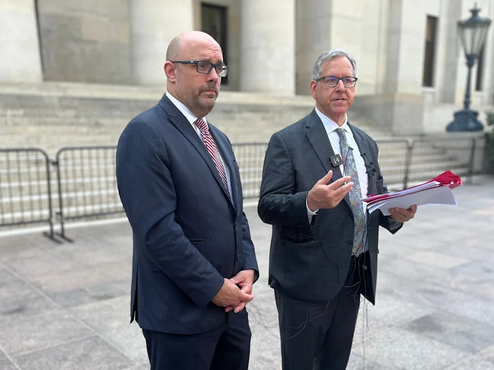 Former state Rep. Jeff Crossman and former Ohio Attorney General Marc Dann speak to reporters outside the Ohio Statehouse on June 25 about their plan to sue over the state's use of unclaimed funds for the new Browns stadium.