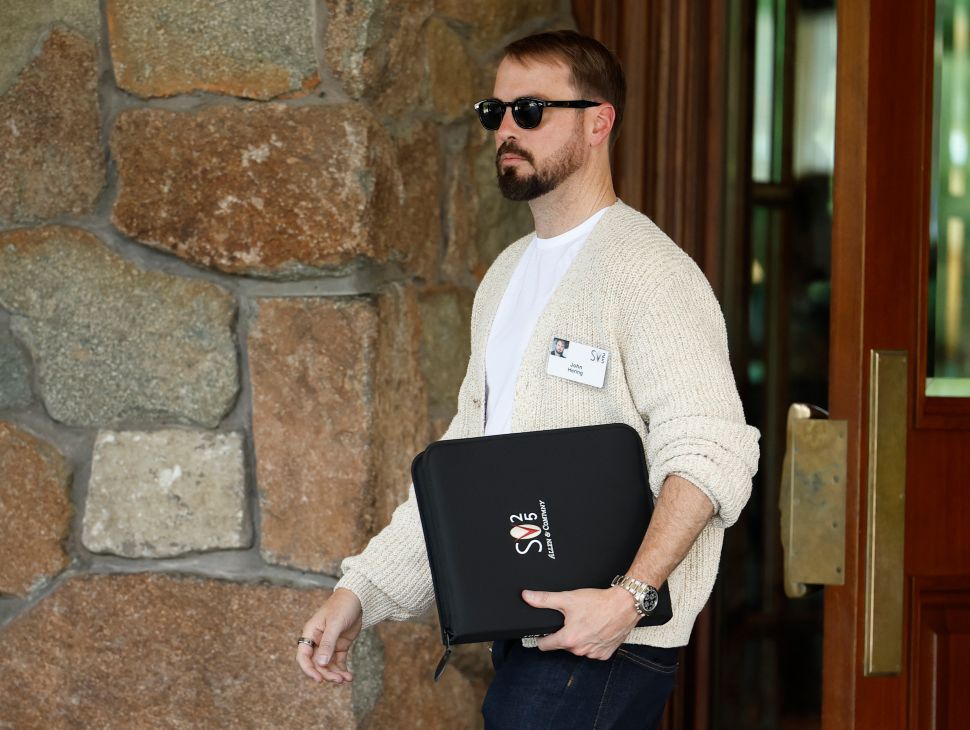 Man in white shirt walks outside