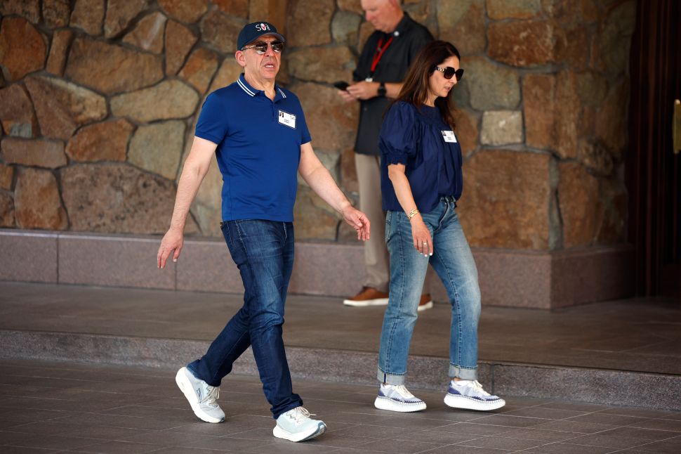 Man in blue shirt walks outside