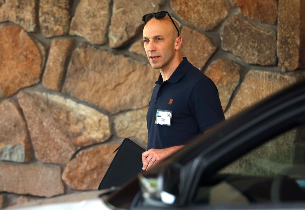 Man in black shirt walks outside 