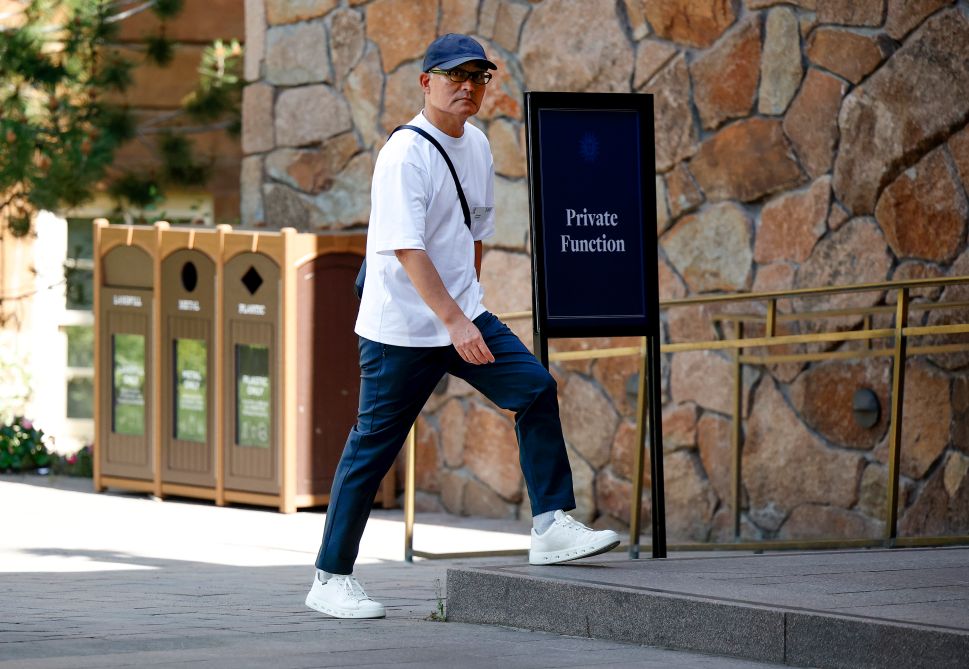 Man in white shirt walks outside