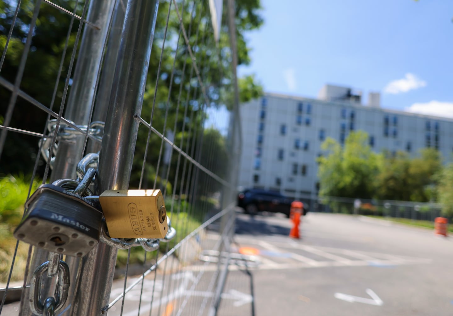 A locked fence keeps people from getting too close to the Riverview condo building.