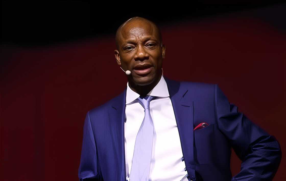 Segun Agbaje speaks on a podium in a purple suit. Segun Agbaje speaks on a podium in a purple suit.