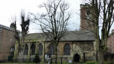 Geograph/Paul Farmer The Grade I listed St Martin-cum-Gregory Church on Micklegate in York, a traditional stone church with a clock tower and trees in the foreground.