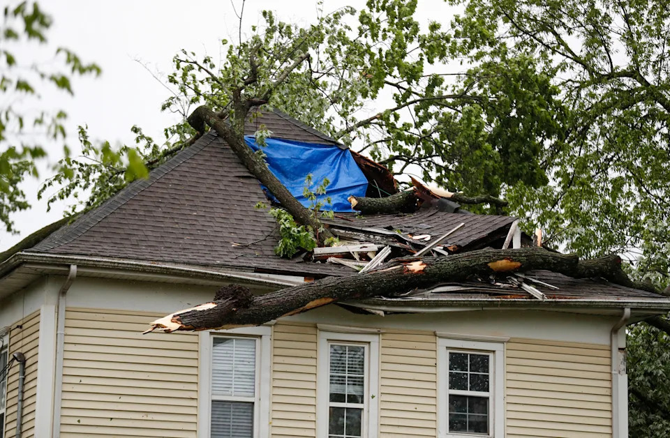 A tree on a house near West Elm Street and South Douglas Avenue after strong storms rolled through the area on Tuesday, April 29, 2025.