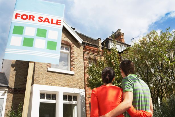 Couple outside a home for sale