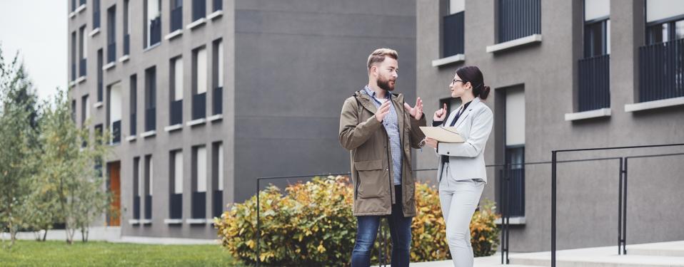 Real estate agent and customer looking for apartment
