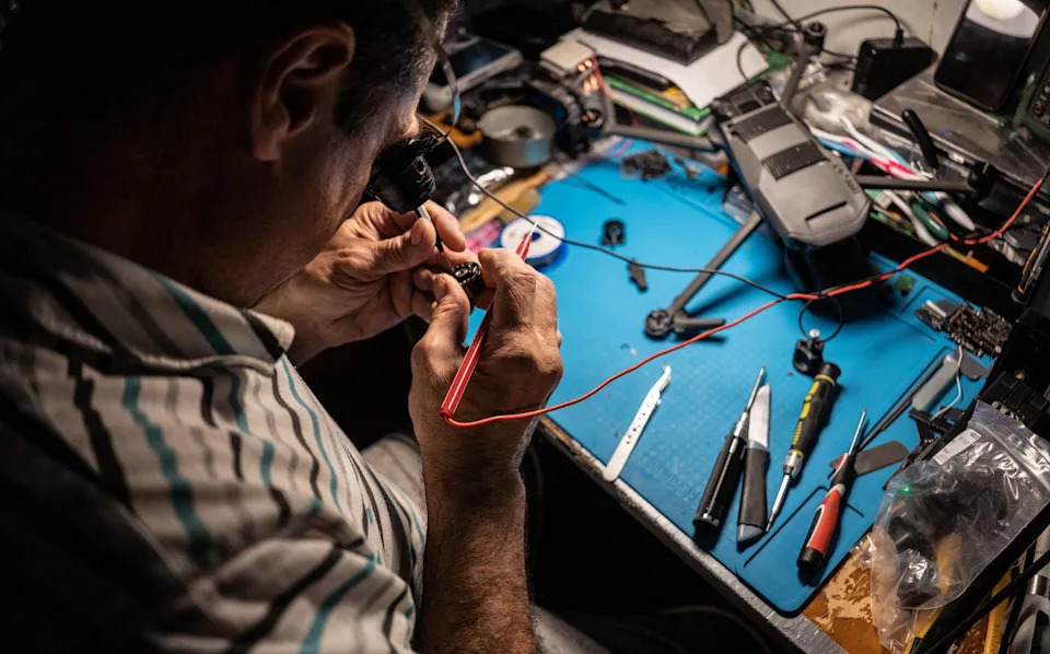 An engineer examines parts of a drone