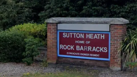 Google A large sign which reads Sutton Heath home of Rock Barracks