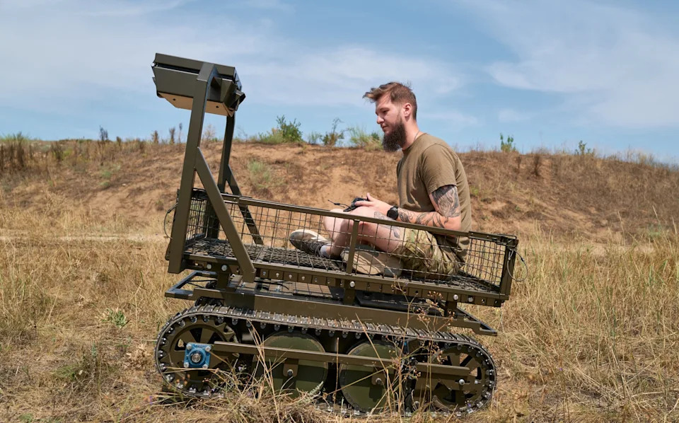 A soldier operates a ground drone