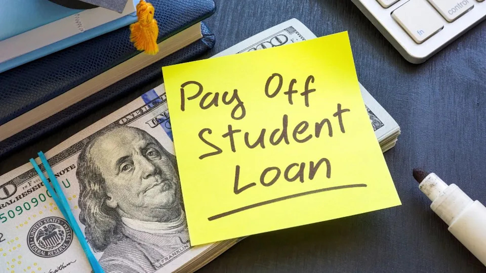 A Bundle of money and inscription Pay off student loan.